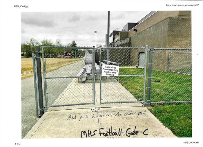  fenced double gate with a sign stating Authorized Personel Only. No Students Allowed. 